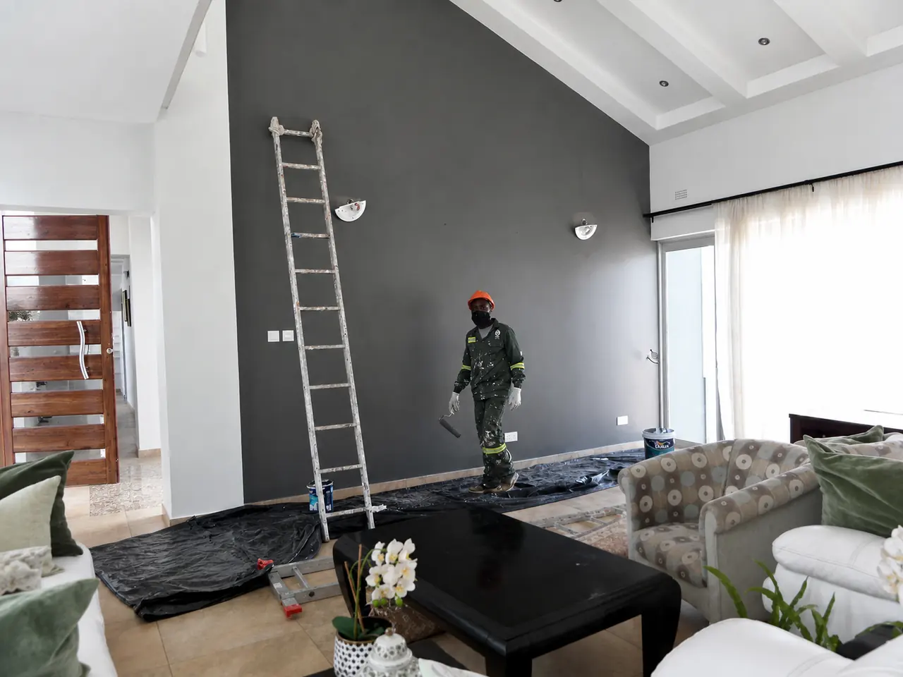 Open-plan interior renovation Chisipite Harare — feature wall and coffered ceiling in a living space