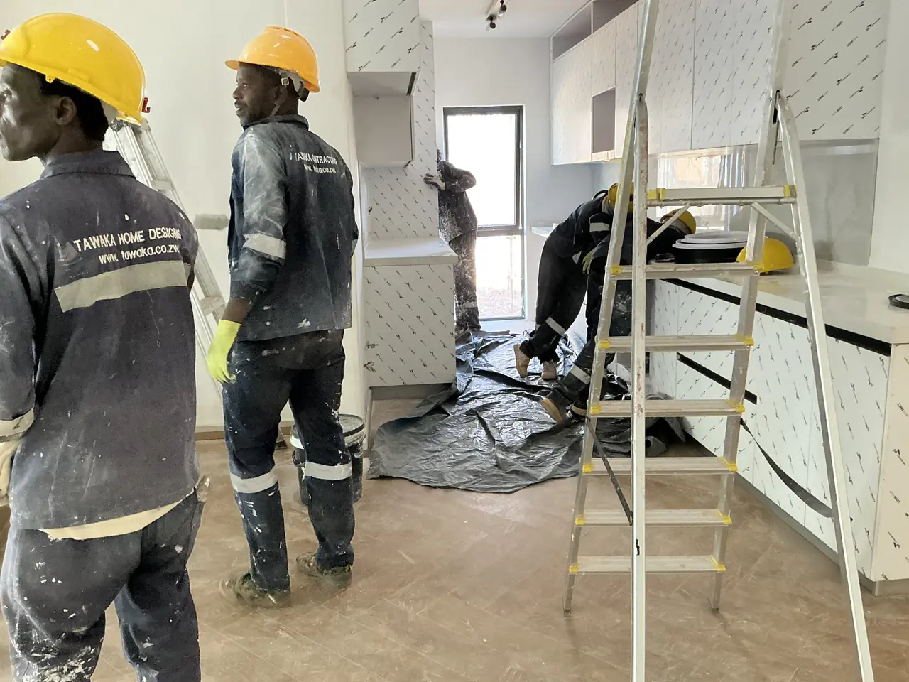 Interior fit-out Harare — Tawaka Contracting crew working inside a kitchen renovation with ceiling and services complete
